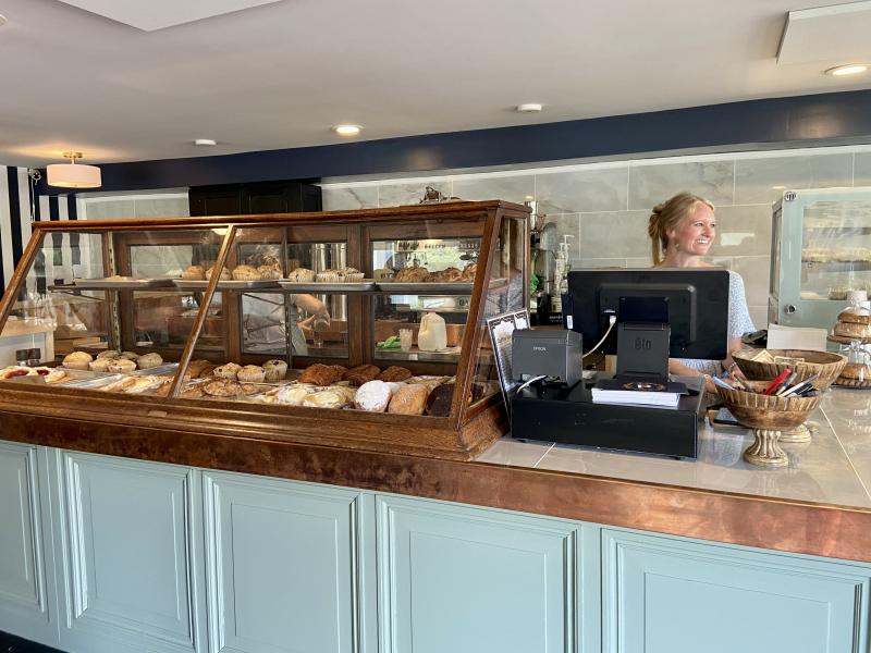 Ashley Skarda smiles at a customer from behind an antique display case sourced from an 1860s peanut roaster on the Wildwood, N.J., boardwalk. ELLEN DRISCOLL PHOTO